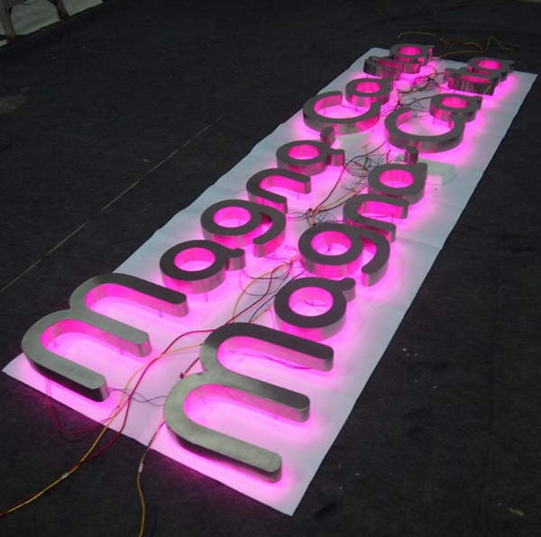 3D LED halo-lit channel letter sign with coloured backlighting, used for modern retail and hospitality signage.