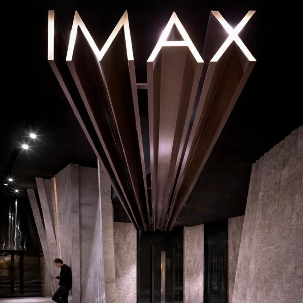 3D structural letter signage integrated into architectural facade for commercial branding