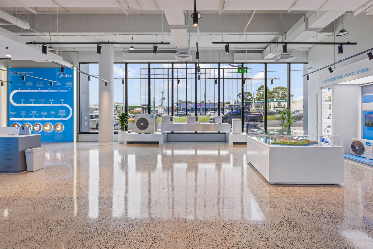 Midea showroom floor with the product wall and feature displays lit