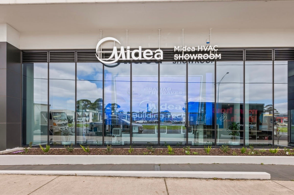 Transparent LED mesh display behind the Midea glass facade by day
