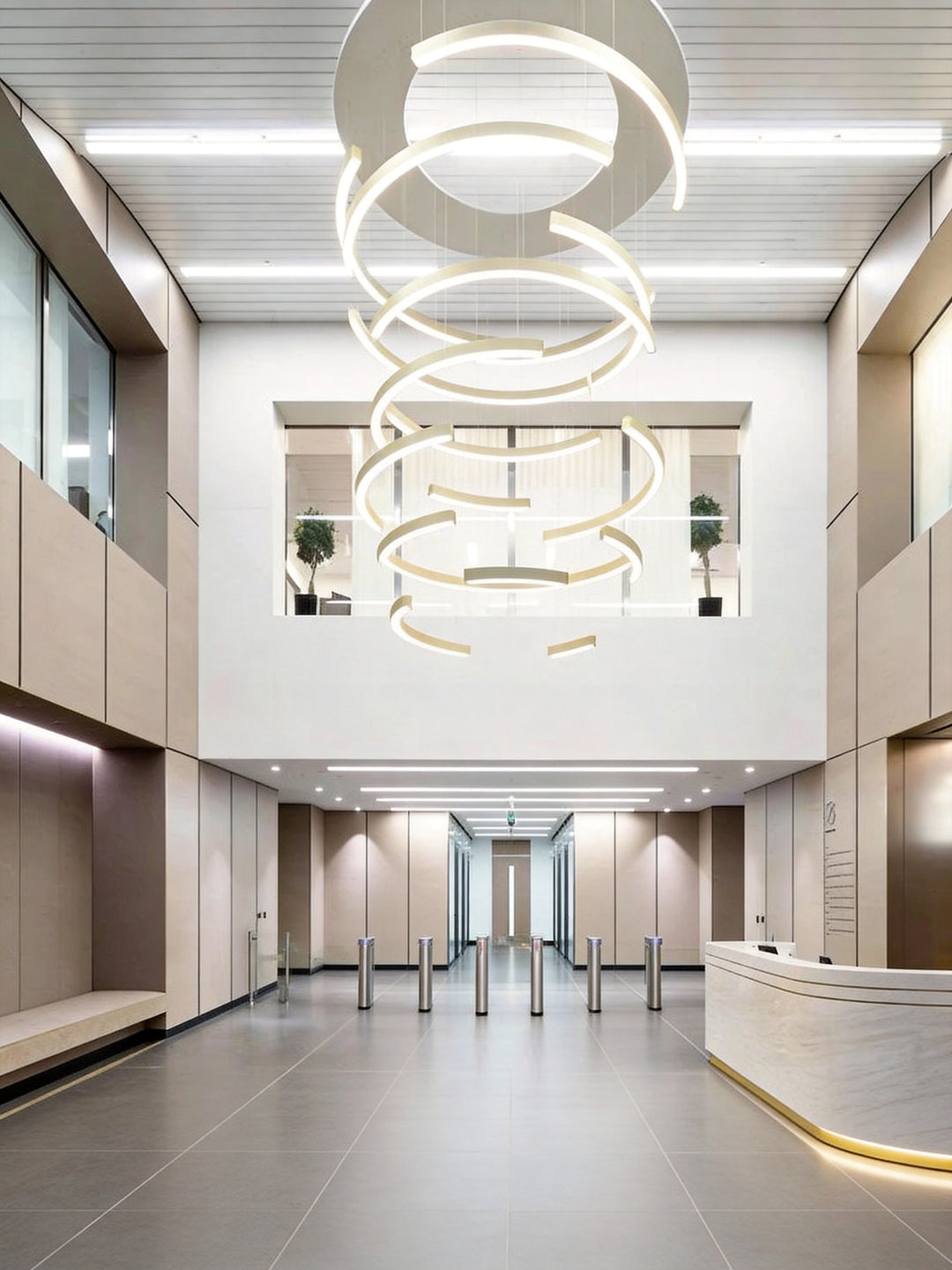 LumiHalf Ring Bespoke Lighting by Lucretia, custom stacked half-ring LED chandelier installation in a double-height commercial building lobby with reception desk