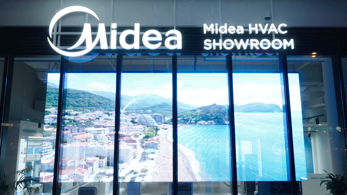 Midea Melbourne HVAC showroom facade after dark, signage and LED display lit
