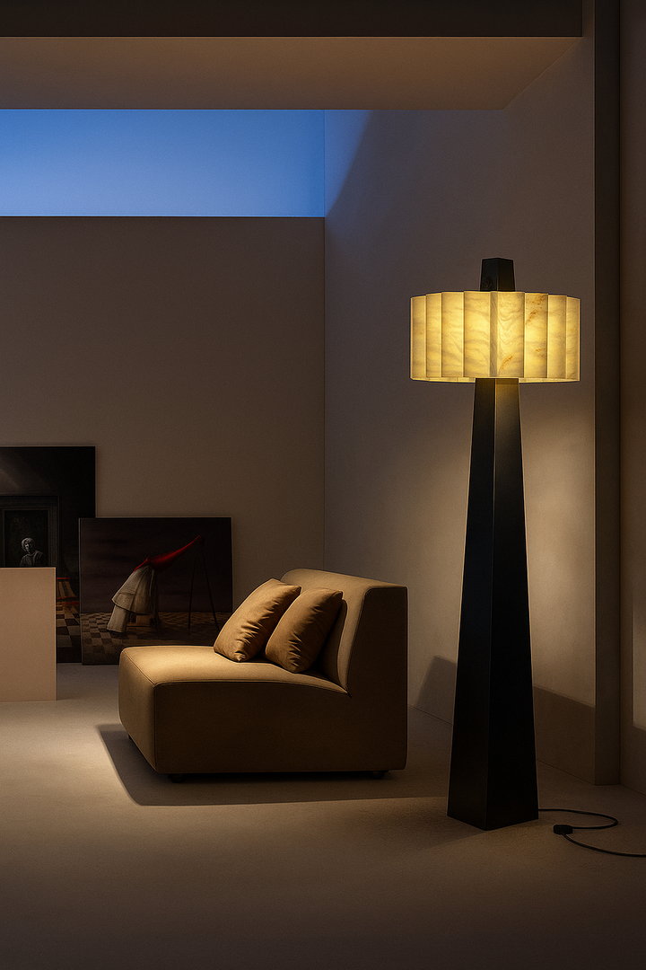 Alabaster Grandeur Floor Lamp creating soft ambient lighting beside a lounge seating area.