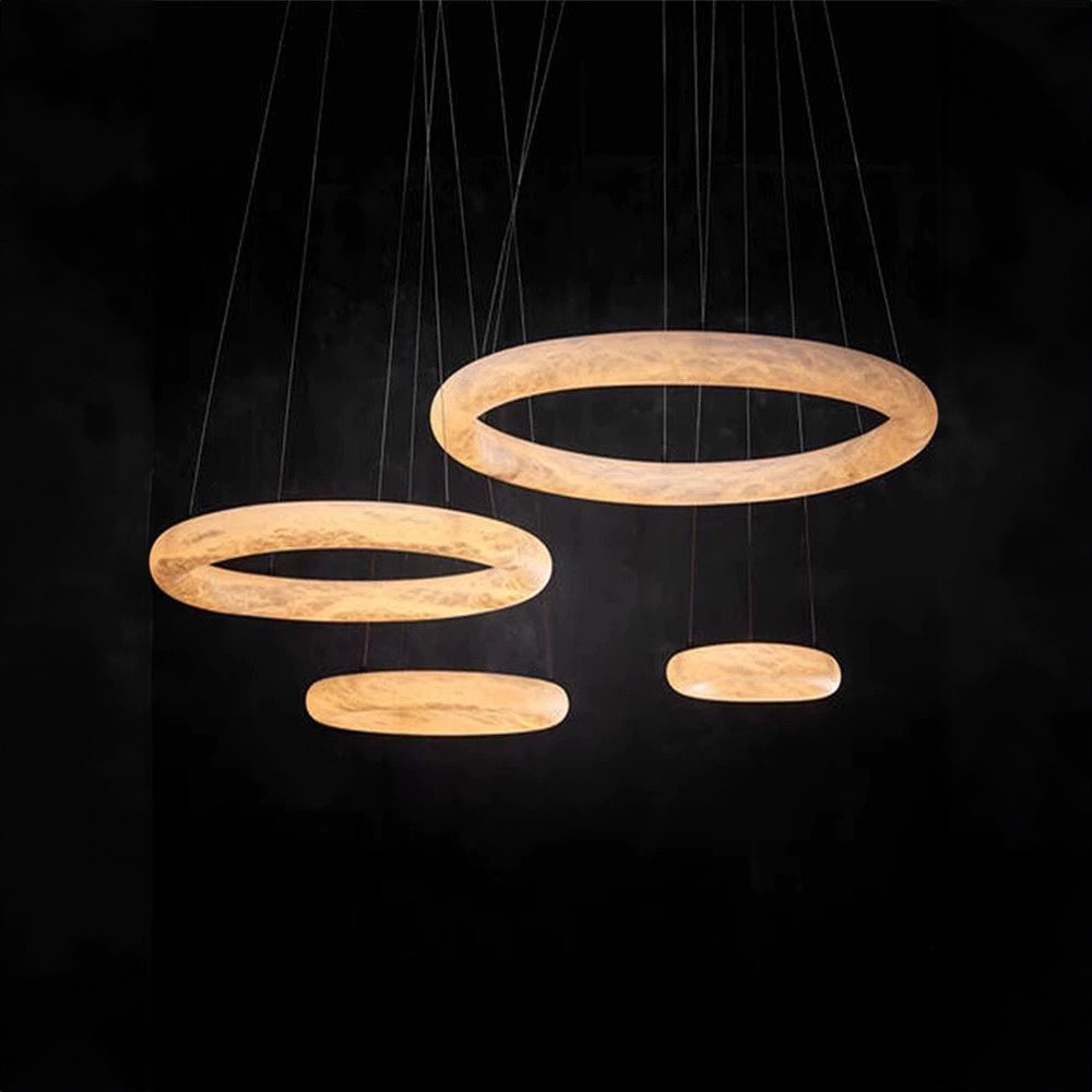 modern alabaster halo ring pendant light arrangement providing diffused ambient lighting suitable for luxury homes high end interiors and contemporary ceiling lighting designs