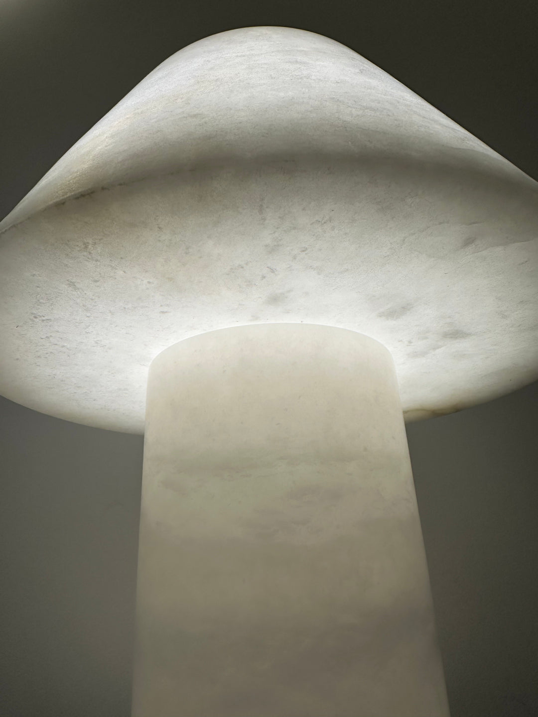 Close-up of alabaster table lamp showing natural stone veining and smooth handcrafted finish for premium interior styling.