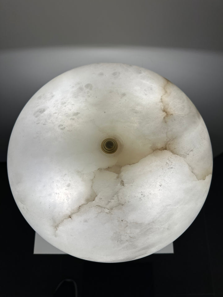 Close-up of alabaster table lamp showing natural stone veining and handcrafted texture for premium interior styling.