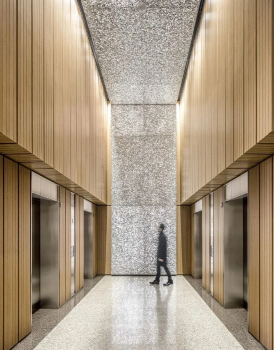 Aluminium foam architectural wall panels installed in a lobby with integrated lighting design