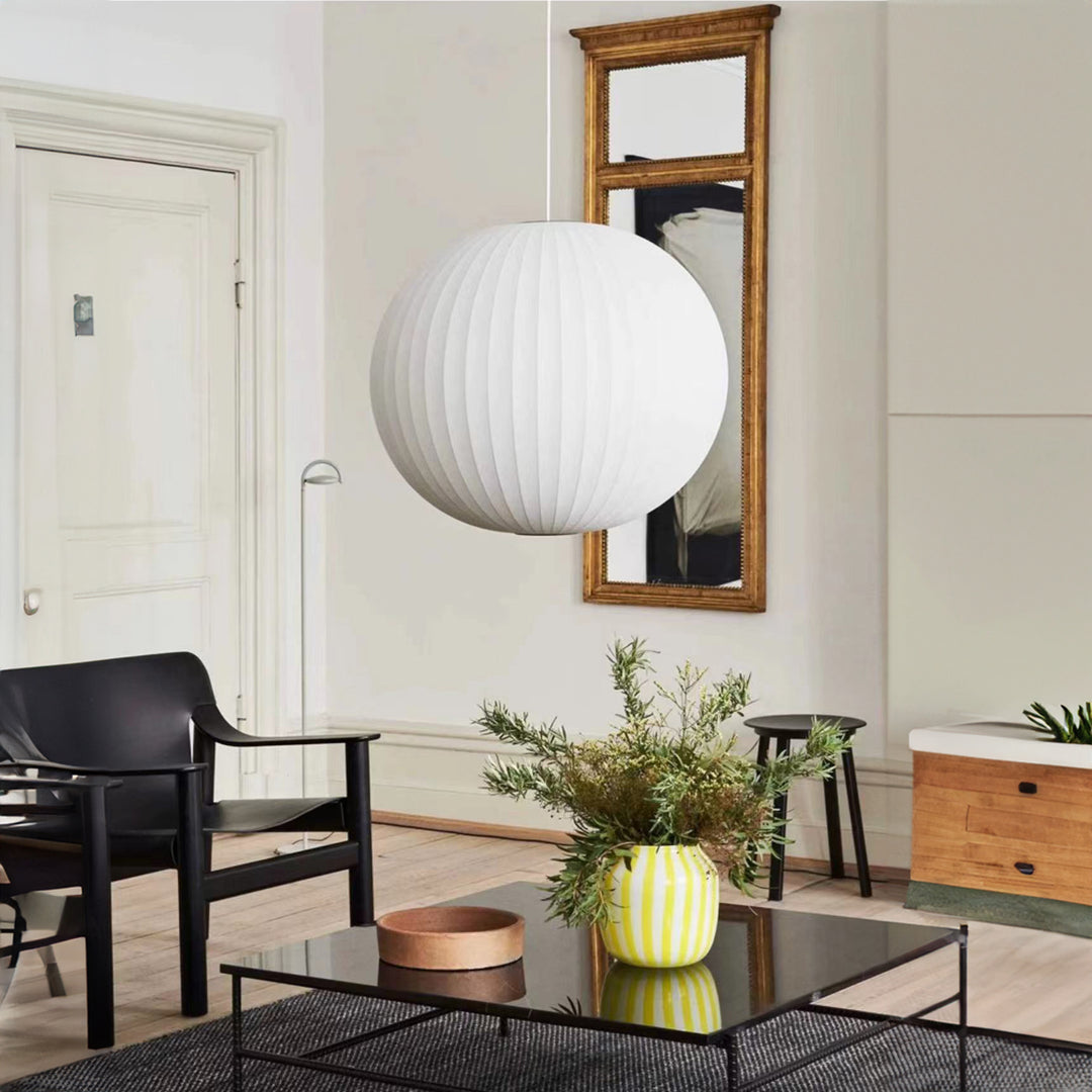 a pendant light used as a central visual element in a living room, providing soft ambient illumination and a balanced spatial focus