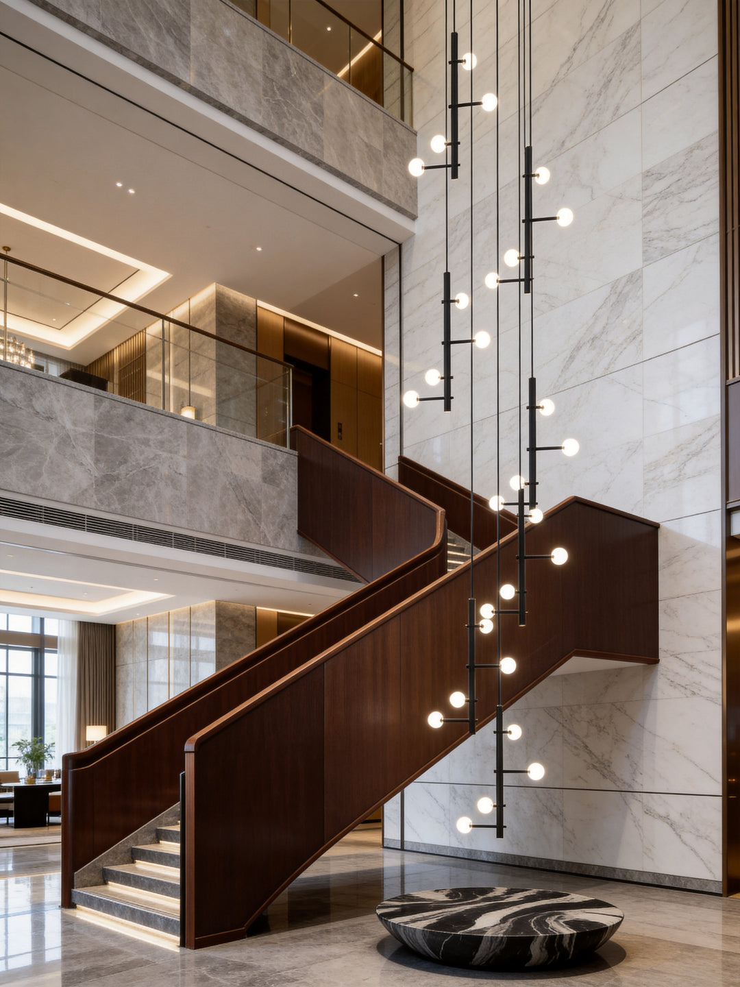 Architectural globe pendant lighting feature designed for hotel lobbies, staircase voids, and commercial interiors.