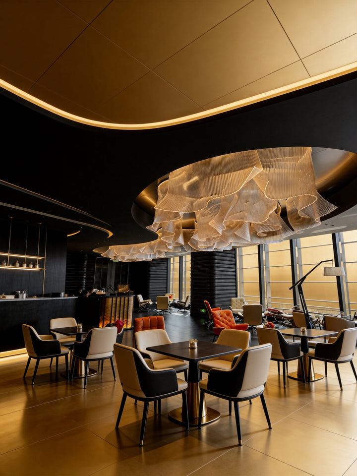 Architectural bespoke pendant light installed in a contemporary hospitality venue with luxury commercial interior styling.
