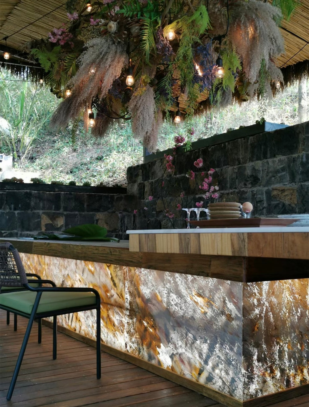 Backlit ultra-thin marble stone panels applied to a bar counter in a hospitality interior