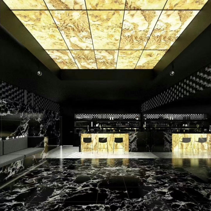 Backlit ultra-thin marble ceiling panels creating illuminated stone surfaces in a luxury interior
