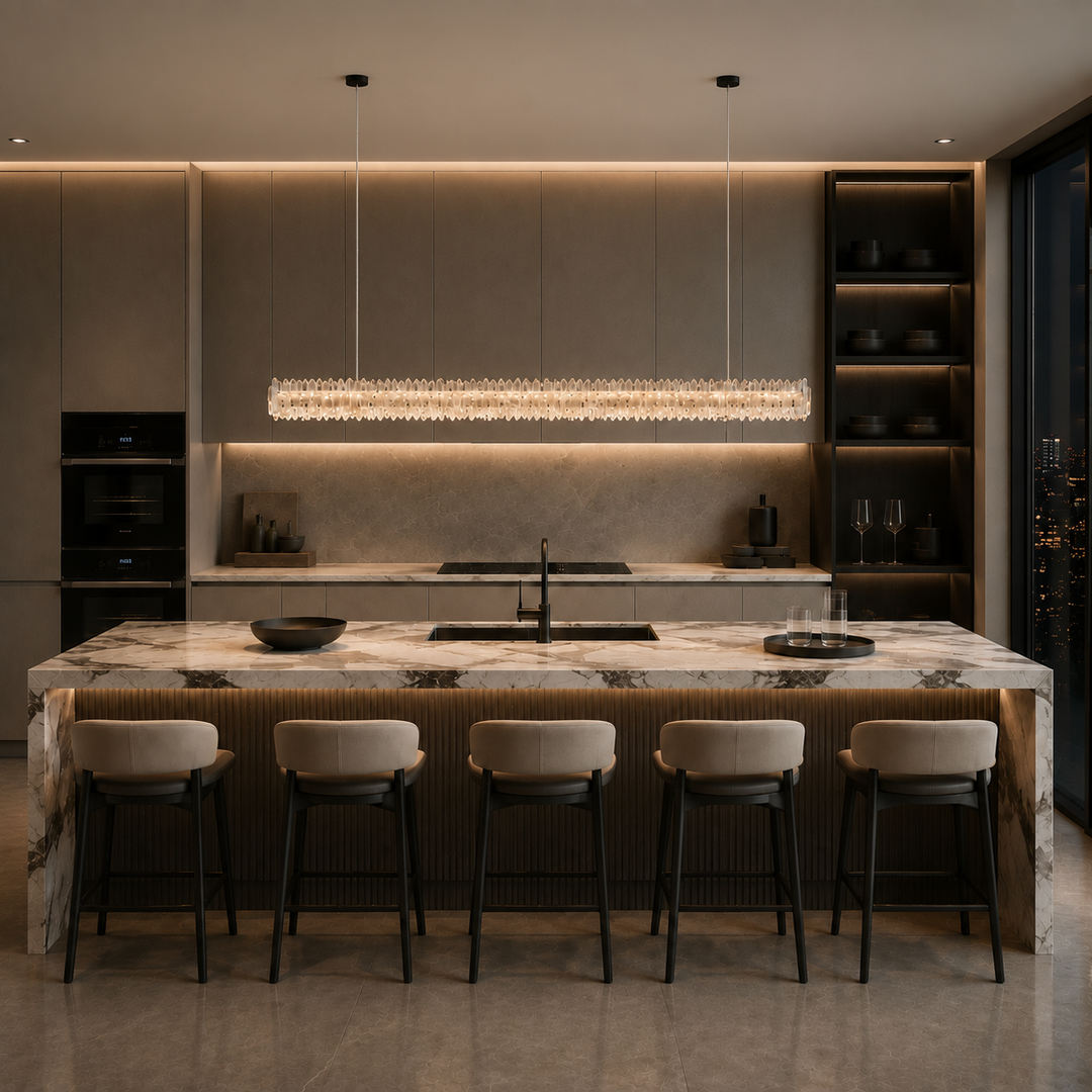 Modern luxury kitchen featuring the Belo Glacia crystal linear pendant light above a stone kitchen island with warm architectural lighting.