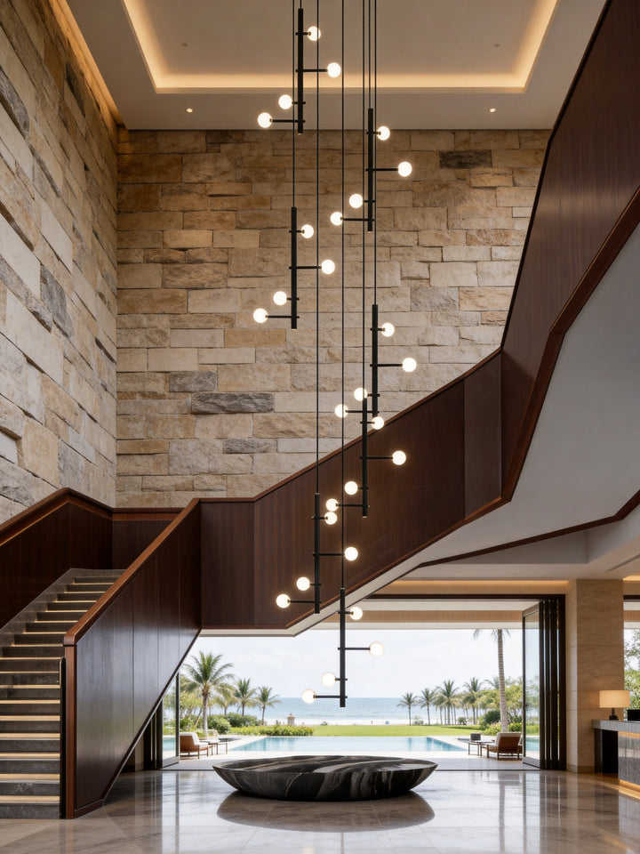 Bespoke globe pendant light installation for a luxury staircase void and large-scale architectural space.