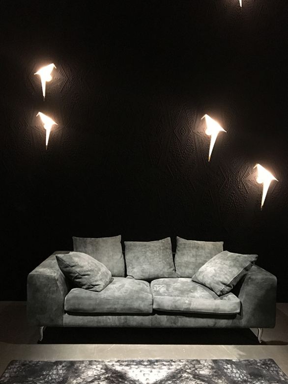 cluster installation of birdcage wall lamps with multiple led birds creating artistic sculptural lighting for modern living room interiors