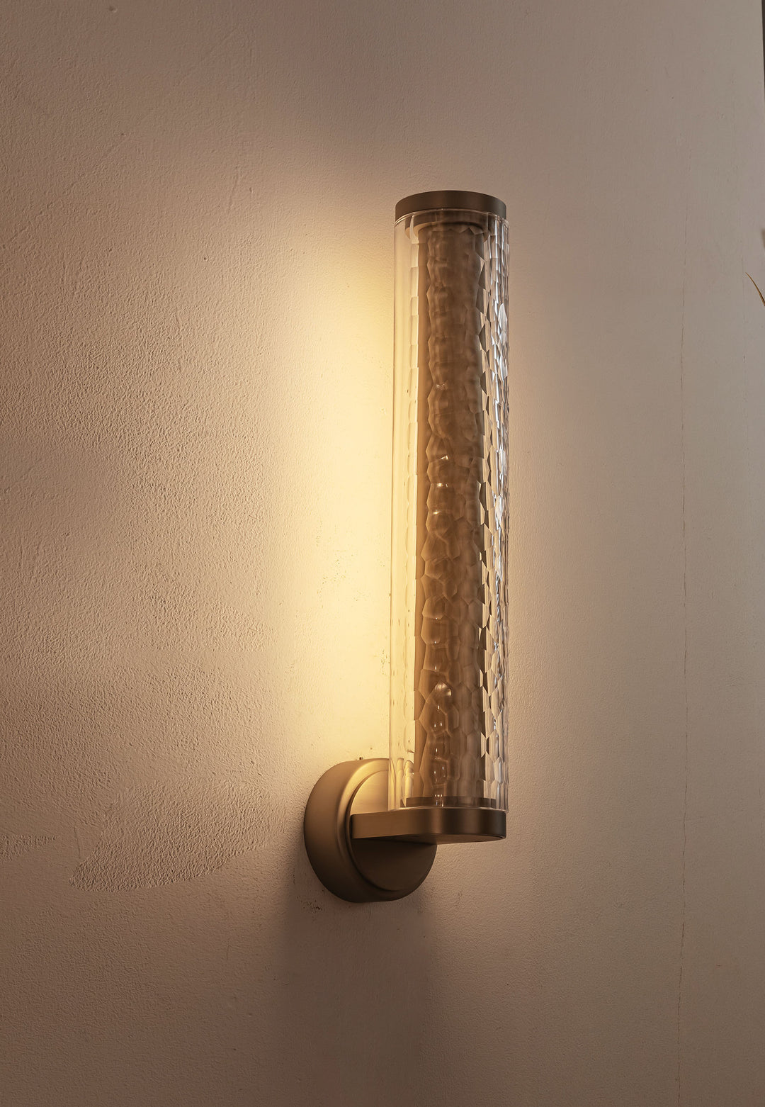 Brushed brass base detail of modern wall light