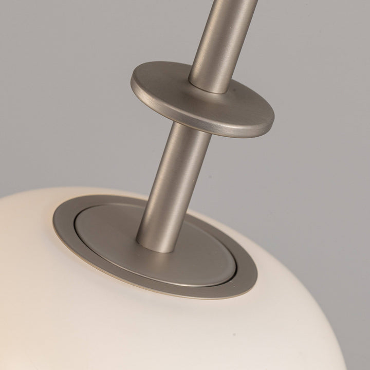 Brushed metal suspension detail of cluster pendant lighting