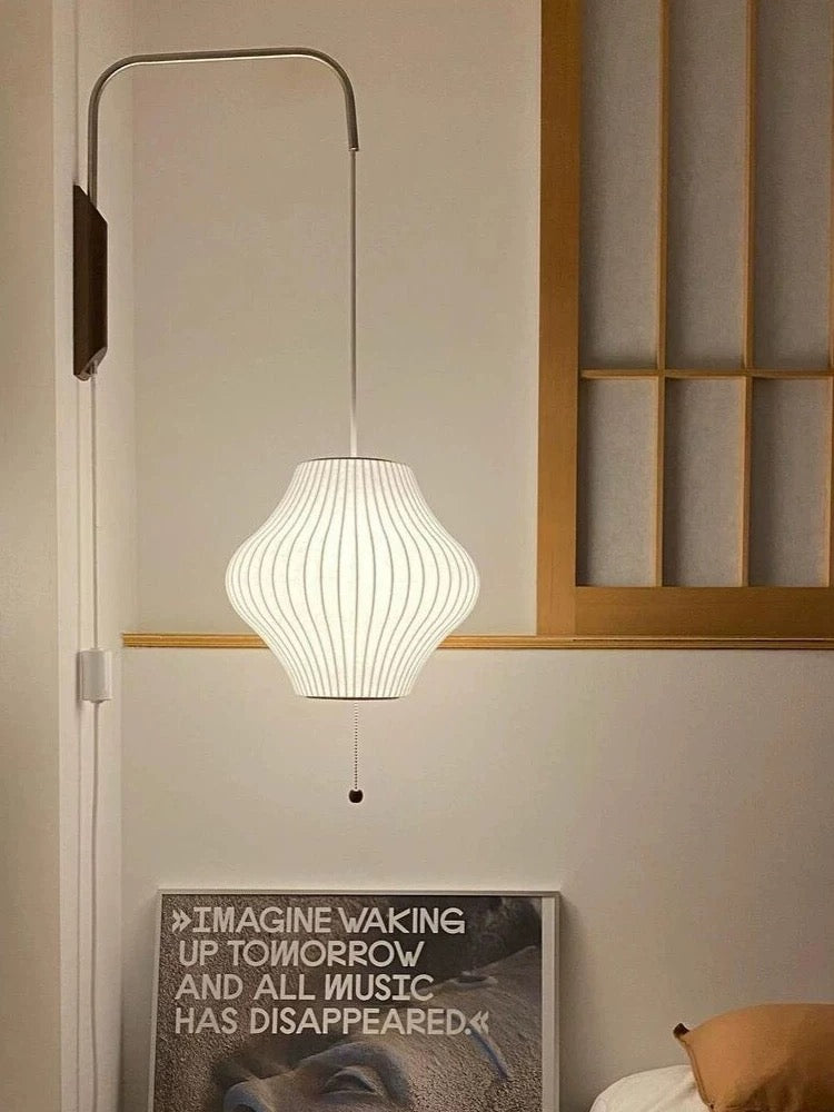 cocoon wall lamp pear shown in bedroom scene with soft ambient glow creating warm inviting atmosphere for modern interiors