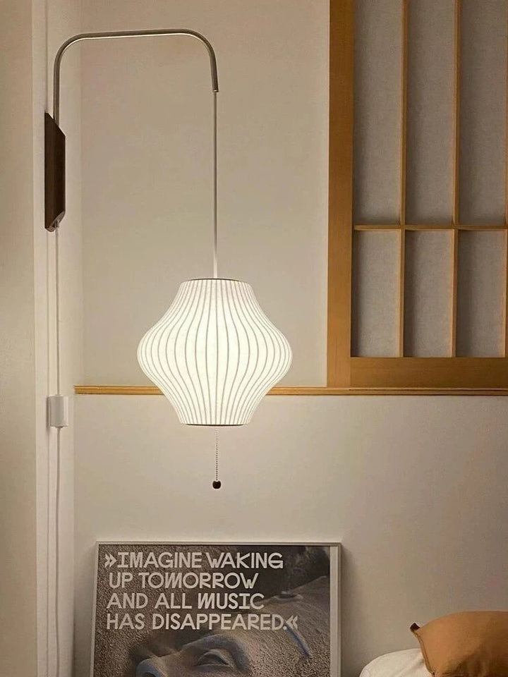 cocoon wall lamp pear shown in bedroom scene with soft ambient glow creating warm inviting atmosphere for modern interiors