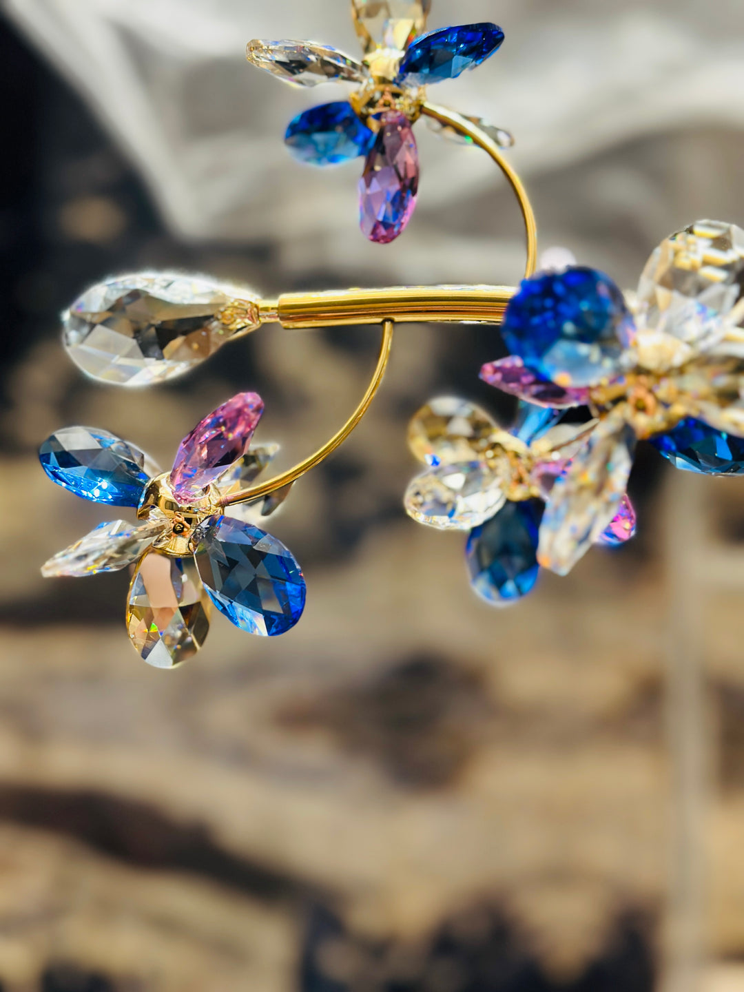 Close-up of Crystal Blossom bespoke lighting featuring hand-crafted K9 crystal flowers with gold-finished branches, showcasing premium crystal detailing and artistic floral design.
