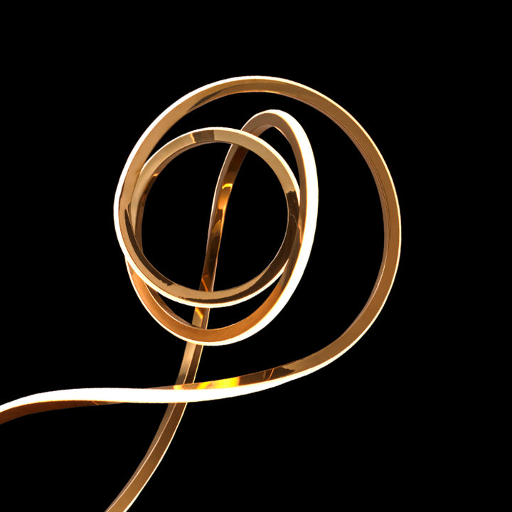 Curved LED Sonata Table Lamp with metallic sculptural loop design offering soft ambient glow for desks, consoles and stylish home decor.