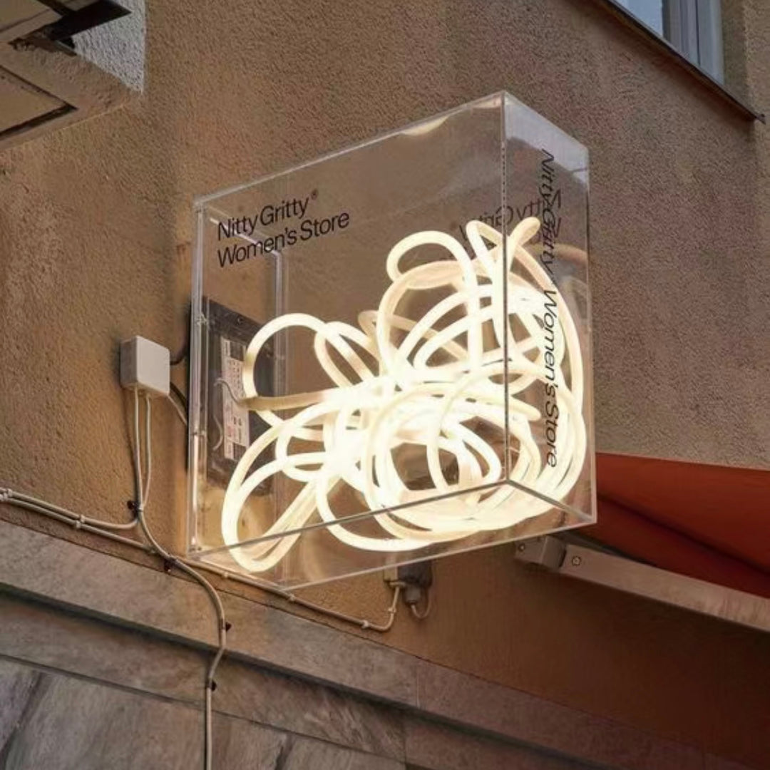 custom neon art box mounted on exterior wall with clear acrylic box and white LED neon lighting