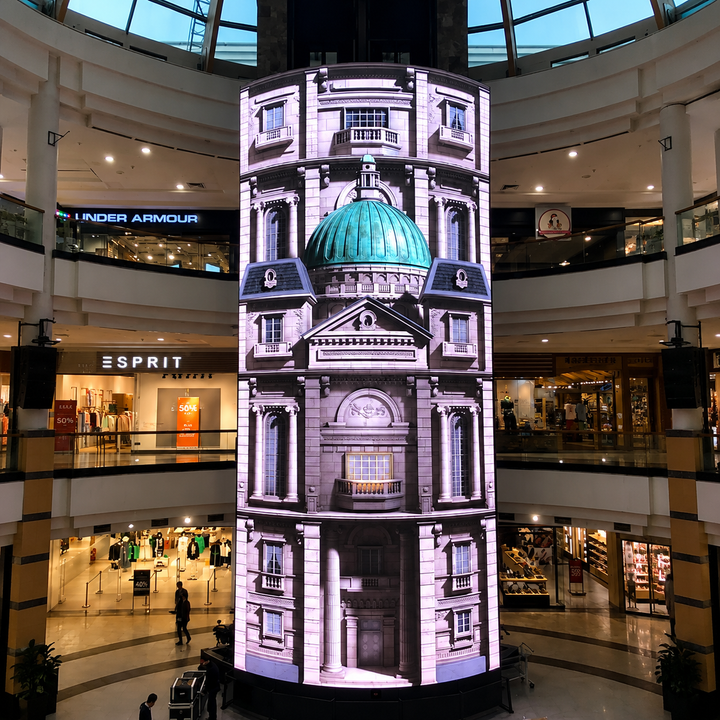 Cylindrical LED display wrapped around a column in a shopping centre atrium