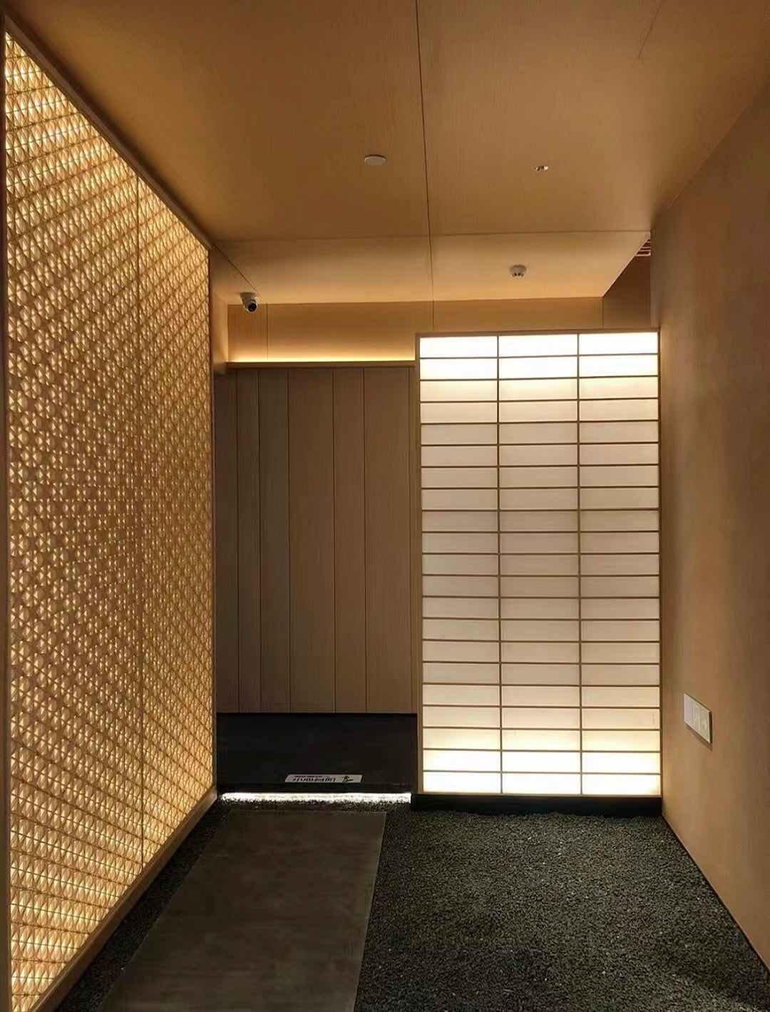 Decorative bamboo wall panels applied in a hotel corridor interior with warm ambient lighting