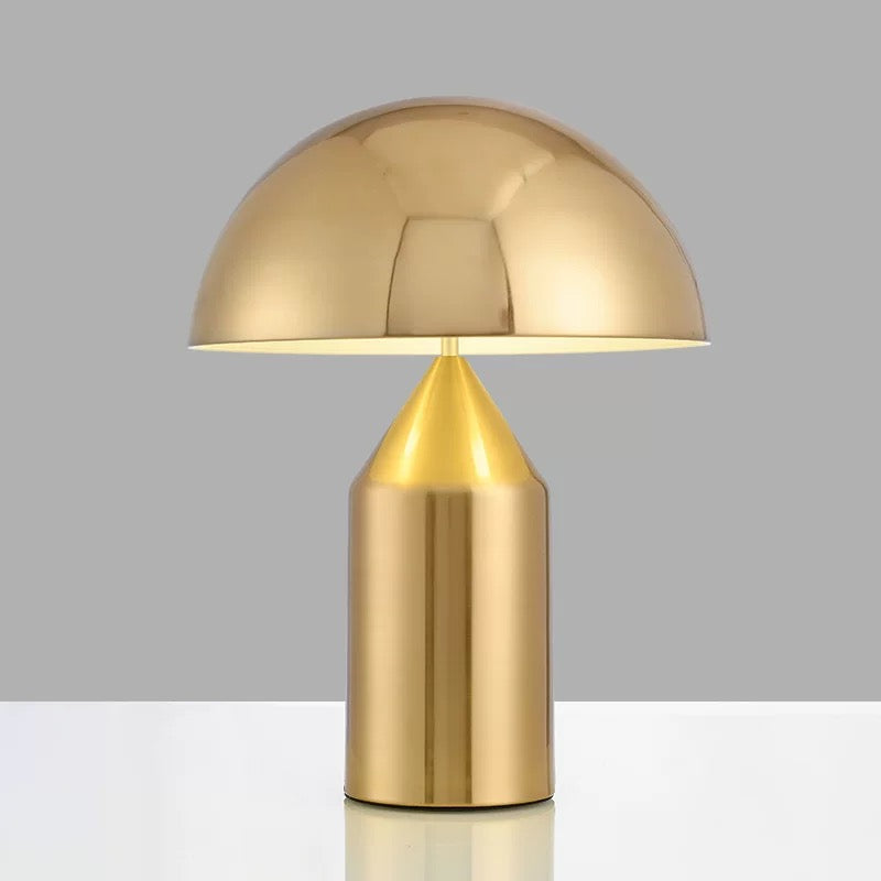 Brushed gold dome table lamp with sculptural metal design, ideal for bedside tables, consoles and modern home lighting.