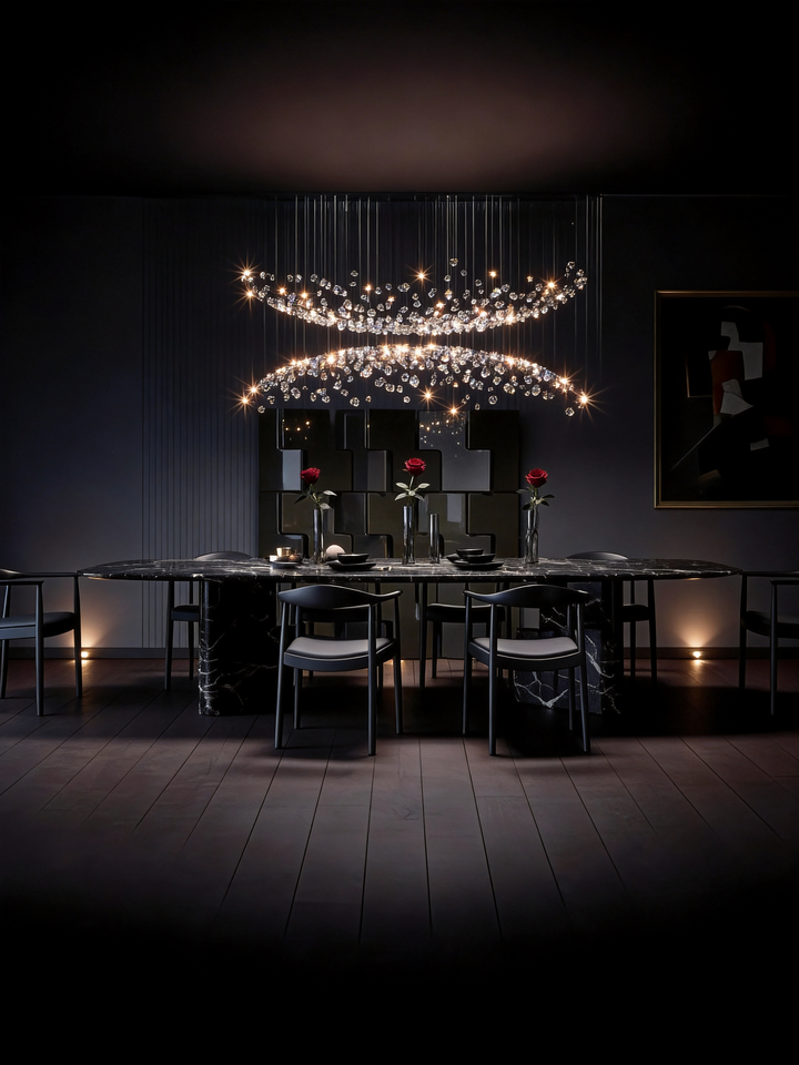 Double arc sculptural crystal pendant light above a black marble dining table in a dramatic dark luxury dining room with rose table setting, NOVAÉ Spiral 2220 by Lucretia