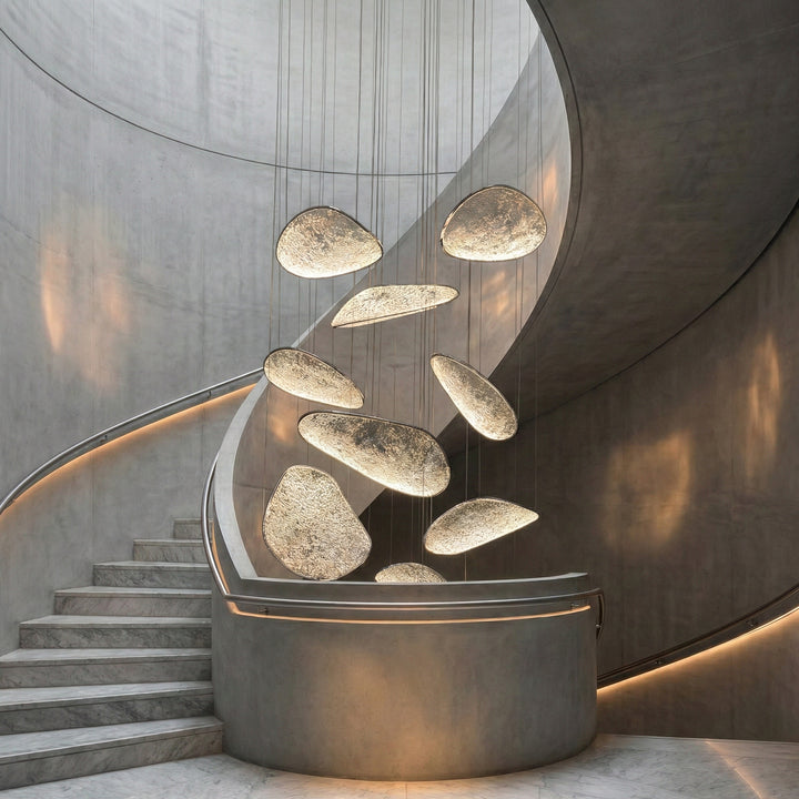 Modern chandelier lighting in double-height staircase interior