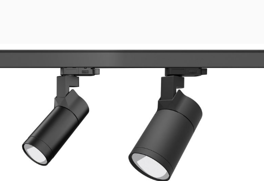 Dual head semi wall washer LED track light installed on track system for uniform wall lighting in commercial and retail interiors