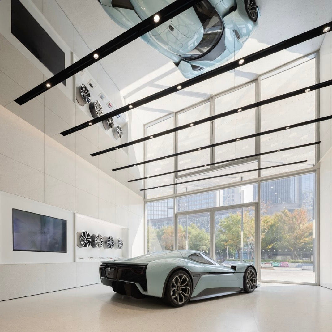 EcoChar decorative wall panels installed on ceiling and walls in a modern car showroom interior.