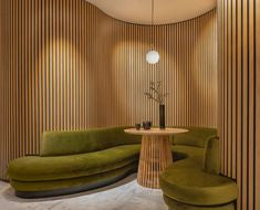 Curved EcoSpin timber louver wall panels creating a warm and enclosed seating area in an interior space