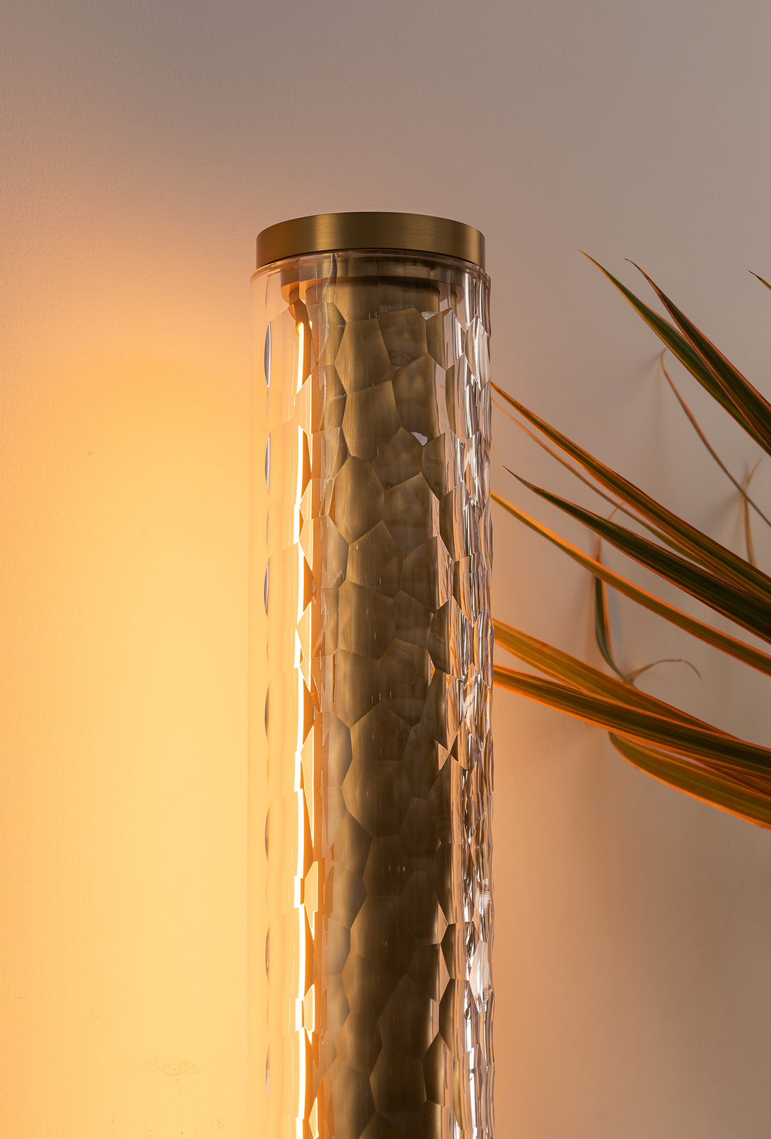 Wall light creating warm glow on feature wall in modern interior