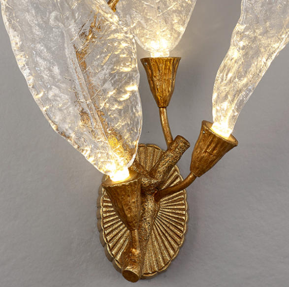 Handcrafted brass and glass leaf wall sconce providing warm diffused illumination, elegant decorative wall light for contemporary homes