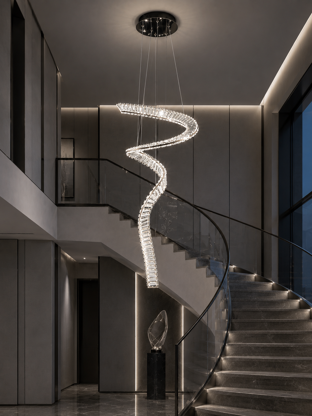 Fluid crystal staircase pendant light in a warm luxury residential void with curved staircase, glass balustrade and sculptural pedestal display, Pharaoh Tour Single Pendant Light by Lucretia