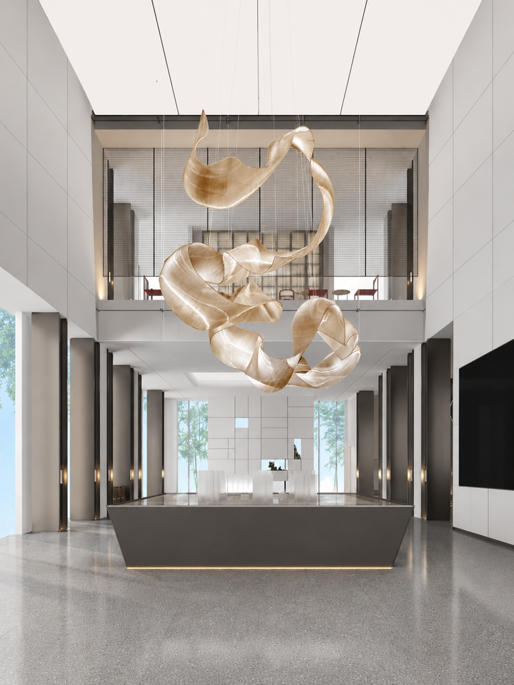 Fluid ribbon-form hand-blown glass sculptural chandelier suspended in a double-height commercial lobby above a reception desk with floor-to-ceiling glazing, Ribbon Bespoke Lighting by Lucretia