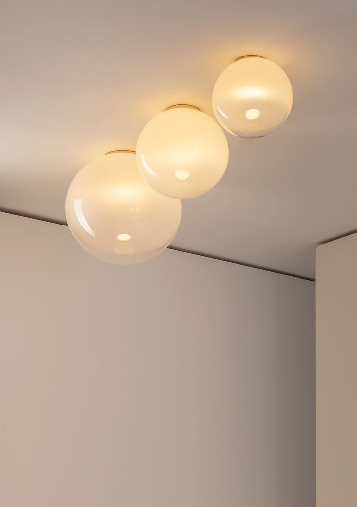 Flush mount glass ceiling light installed in modern room corner