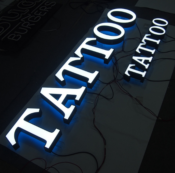 Custom front and back lit channel letter sign for tattoo shop signage in Australia