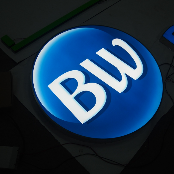 Front lit LED channel letter logo sign with circular illuminated design for storefront signage.