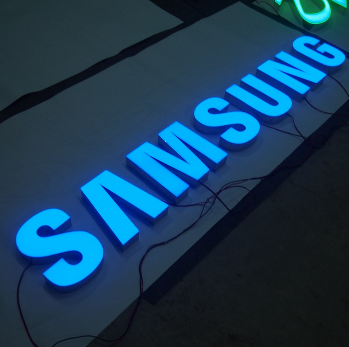 Front lit LED channel letter signage with blue illuminated acrylic letters for retail and commercial buildings