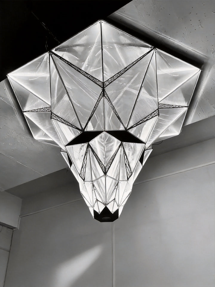 Geometric acrylic and stainless steel sculptural ceiling light photographed from below in a showroom setting, Proteus Bespoke Lighting by Lucretia
