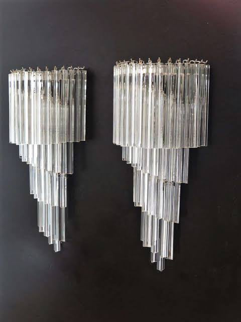 tiered glass designer wall light illuminating a contemporary hallway with soft ambient lighting