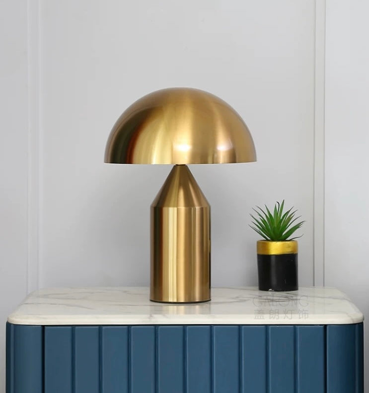 Gold dome table lamp styled on a bedside console, offering warm ambient lighting for bedrooms and contemporary interiors.
