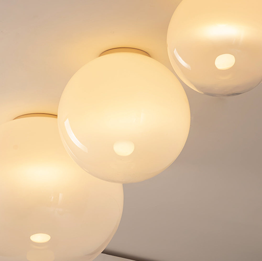 Gradient glass ceiling light close-up with soft frosted white finish