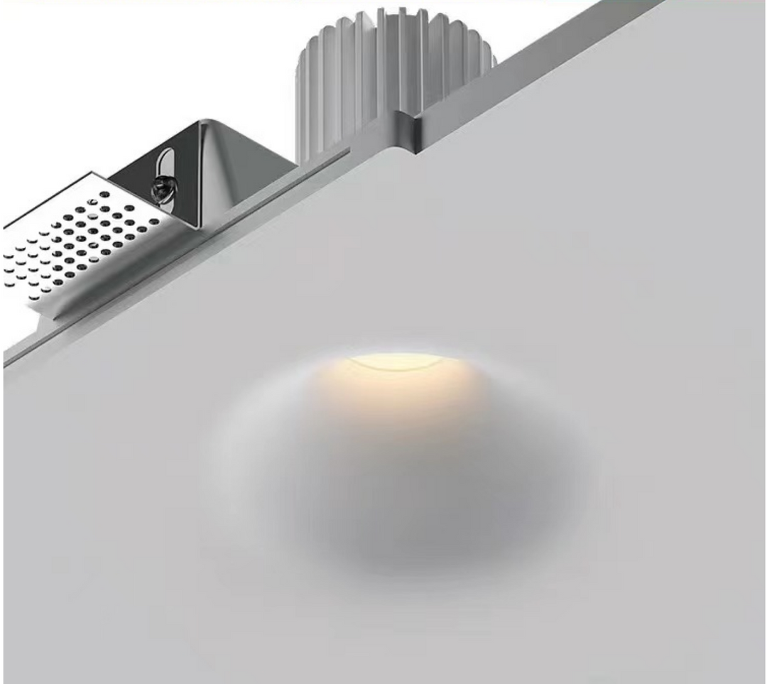 Gypsum 135 trimless downlight installed in plaster ceiling showing seamless architectural finish and soft recessed light output