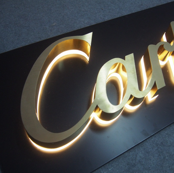 Halo-lit channel letter sign with curved lettering and soft LED backlighting for architectural branding displays.