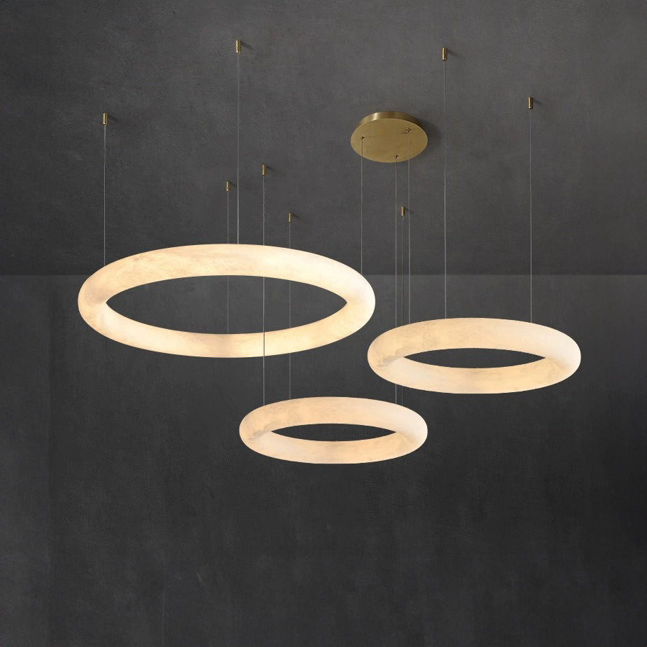 circular alabaster pendant light with layered halo rings creating soft ambient illumination ideal for modern dining rooms kitchens living spaces and architectural interiors