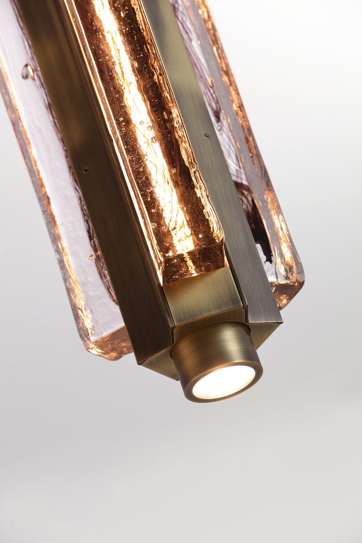 Close-up of hand-blown glass pendant light bottom detail, Running Water trio design with textured glass